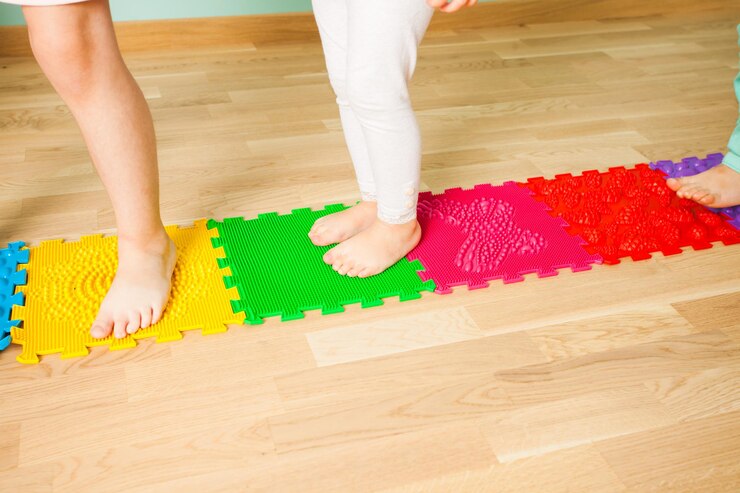 closeup-kid-feet-while-standing-special-massaging-mat_290431-18484.jpg